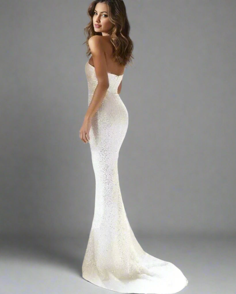 Bride posing in a glamorous mermaid-style fully sequined wedding dress.