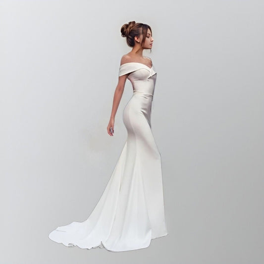 Model in a sleek satin wedding dress with an off-the-shoulder design and sweetheart neckline, featuring a fitted mermaid silhouette and a sweep train.