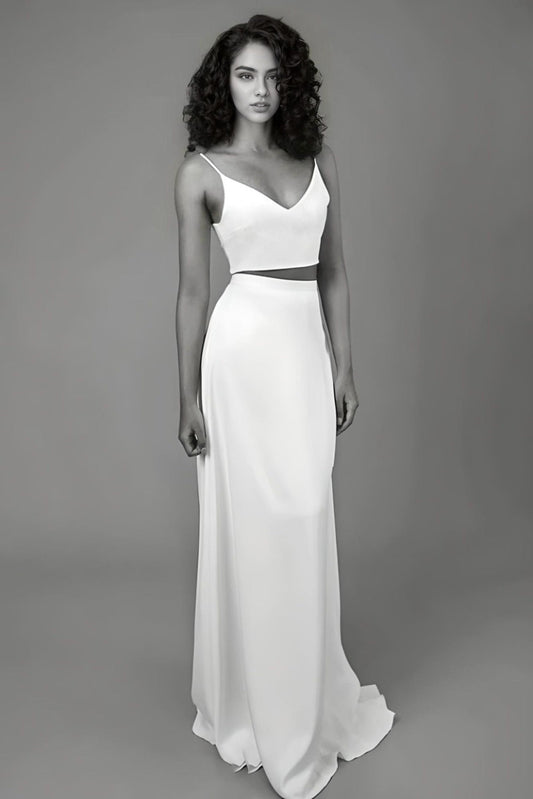 Bride wearing a satin two-piece wedding dress with a V-neck top and spaghetti straps, showcasing a modern and sexy bridal look.