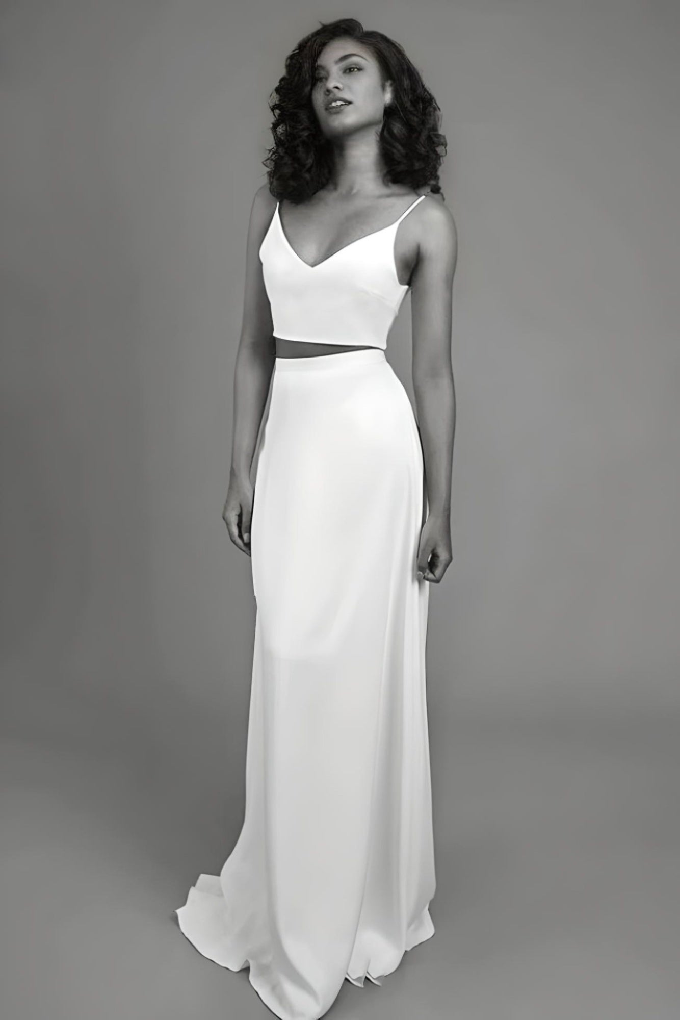 Woman in a sexy two-piece dress, featuring a sweep train and backless design for a bold wedding look.