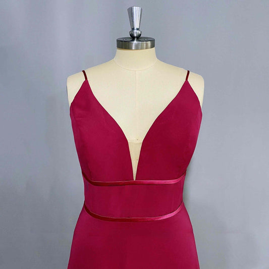 Store mannequin in elegant formal dress featuring a V-neckline, spaghetti straps, and two waist-accentuating straps, ideal for a stylish bridesmaid or prom look.