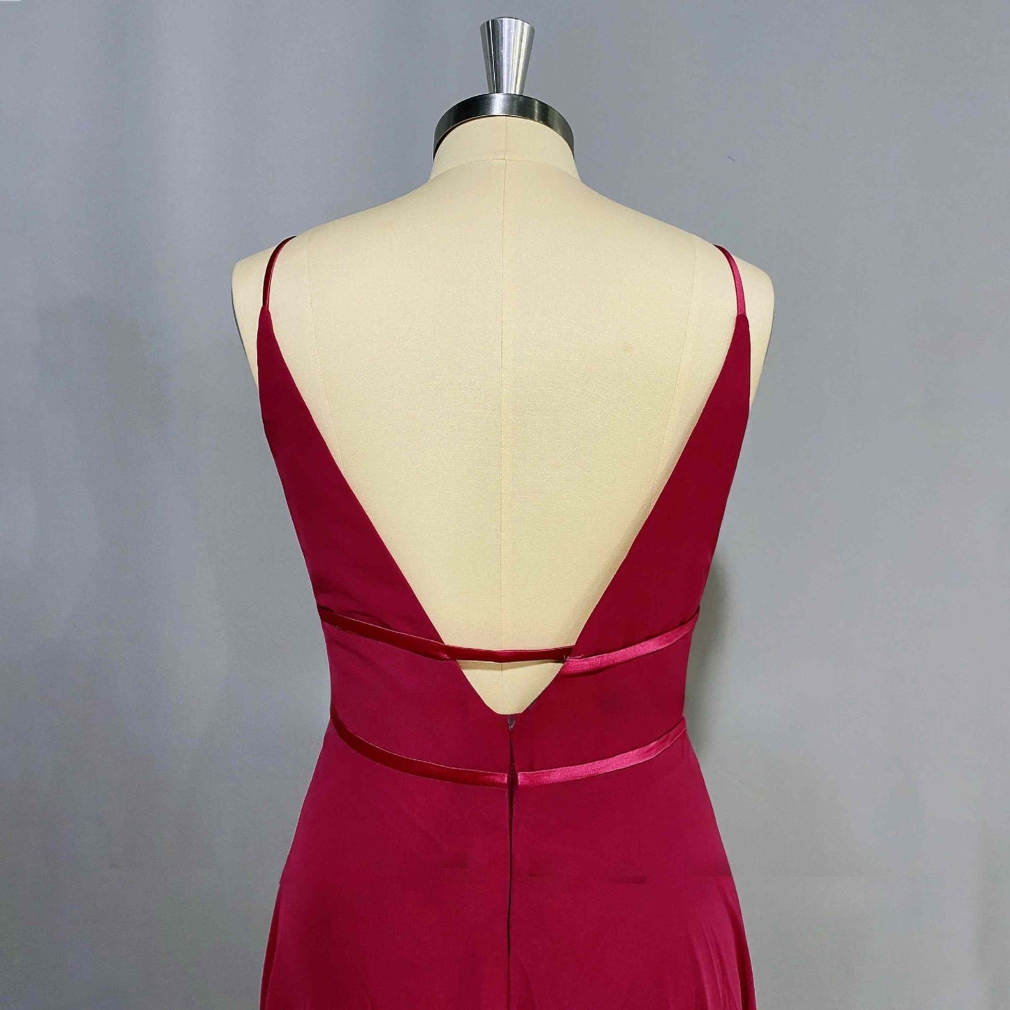Model of a sophisticated formal gown with spaghetti straps, and a flattering waist design, ideal for prom or evening wear.