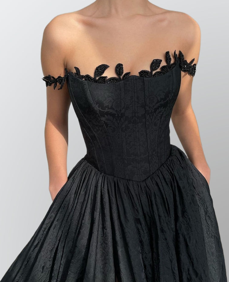 Model posing in the LACIE Formal Dress, with a close-up on the leaves lace straps and fabric pattern.
