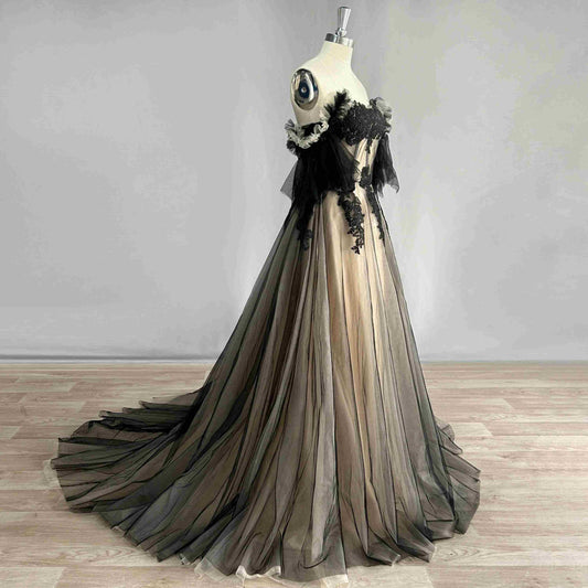 Side view of black MALIKA Formal Dress highlighting off the shoulder sleeve style and train
