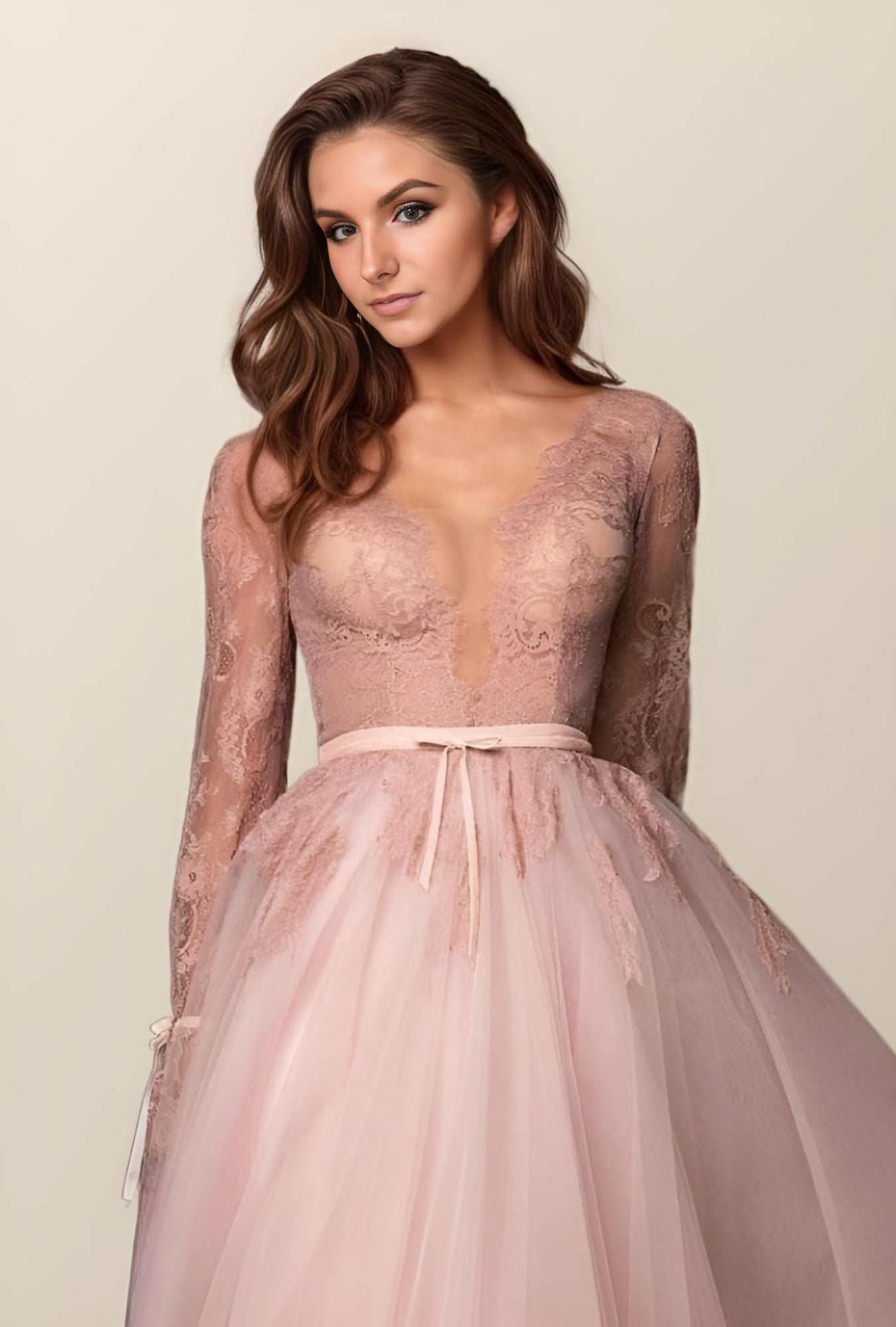 Woman in pink plunging V-Neck Prom Dress, featuring the deep V-neckline and A-line silhouette.