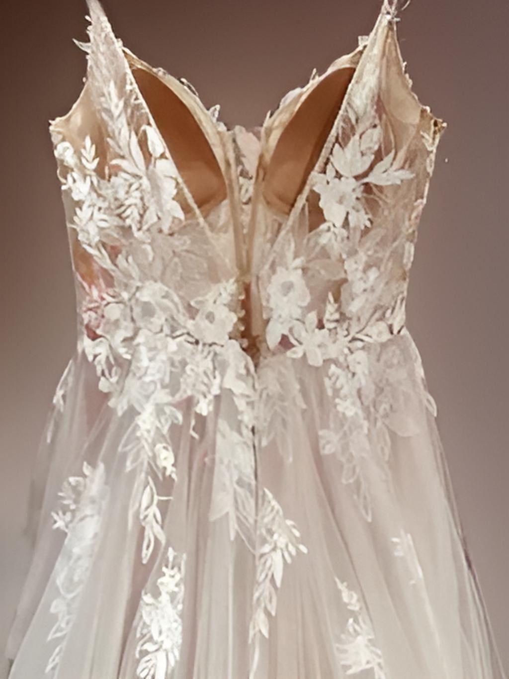 NINA dress on a hanger, showcasing detail of its backless V back design and bohemian flair.