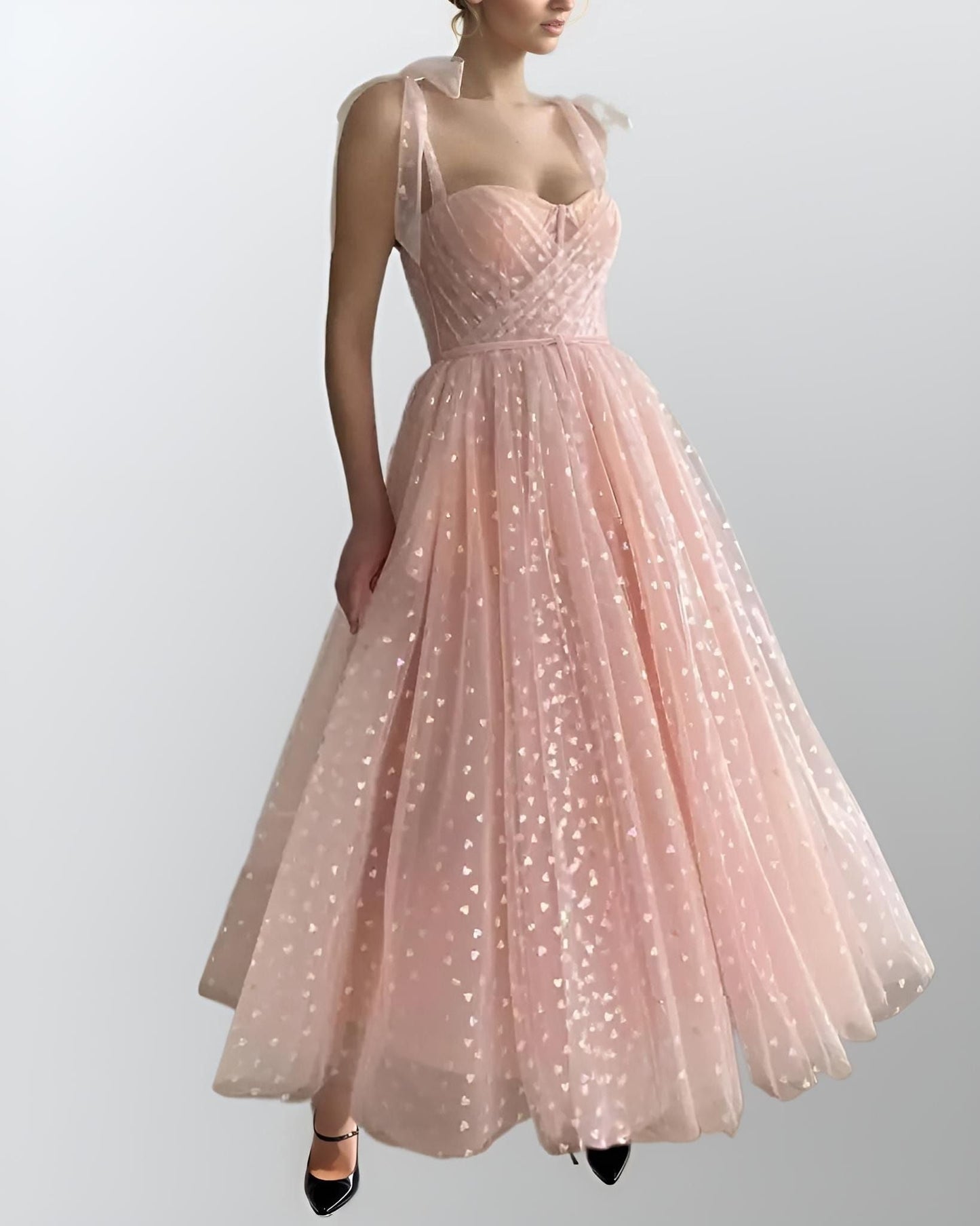 Woman wearing PETRA formal dress with heart tulle design