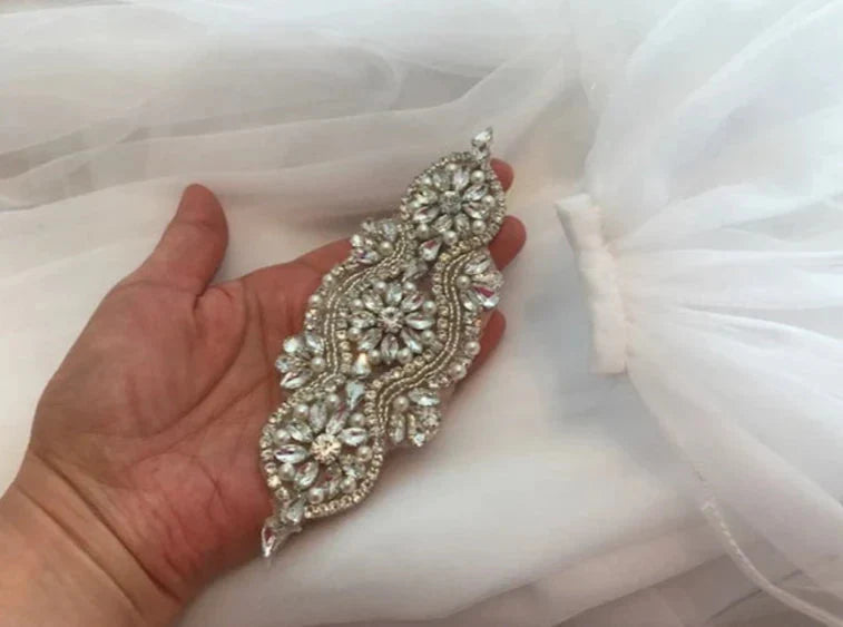 Close-up of rhinestone details on the shoulder cape veil.