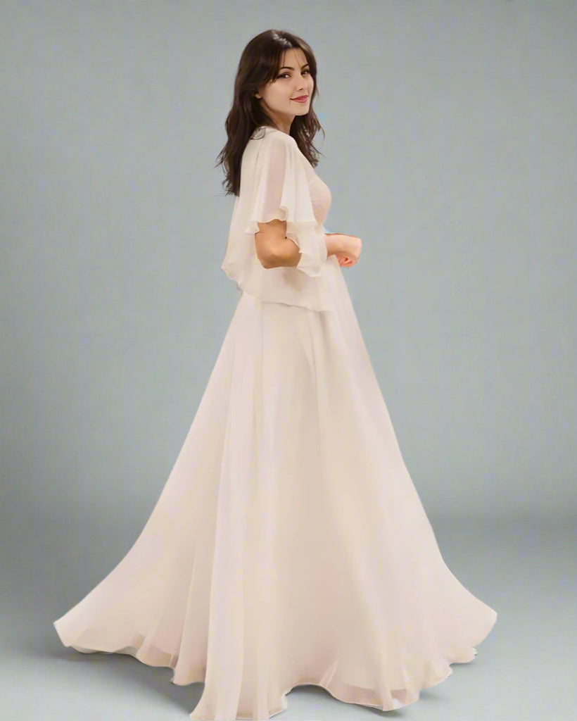 Flowy chiffon wedding dress on pregnant bride from side, showin half sleeves.