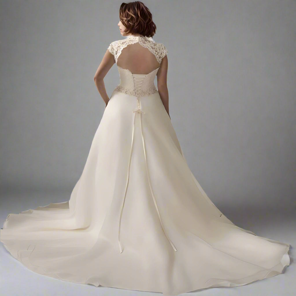 Back view of bride wearing SALMA dress with lace-up back design and backless design and long train.
