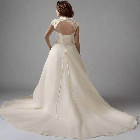 Back view of bride wearing SALMA dress with lace-up back design and backless design and long train.