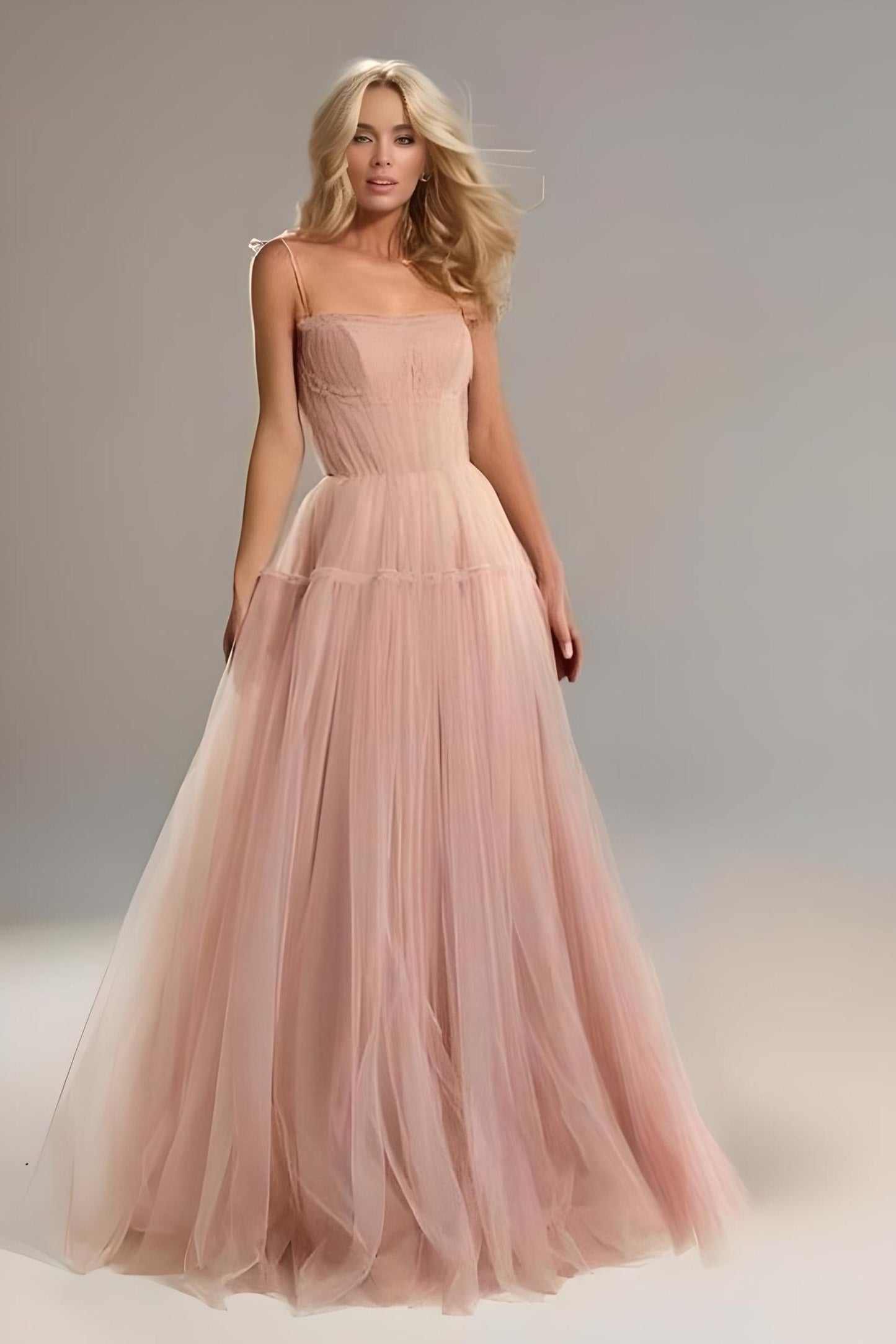 Model walking gracefully in the SARKA formal couture dress in dusty pink tulle.