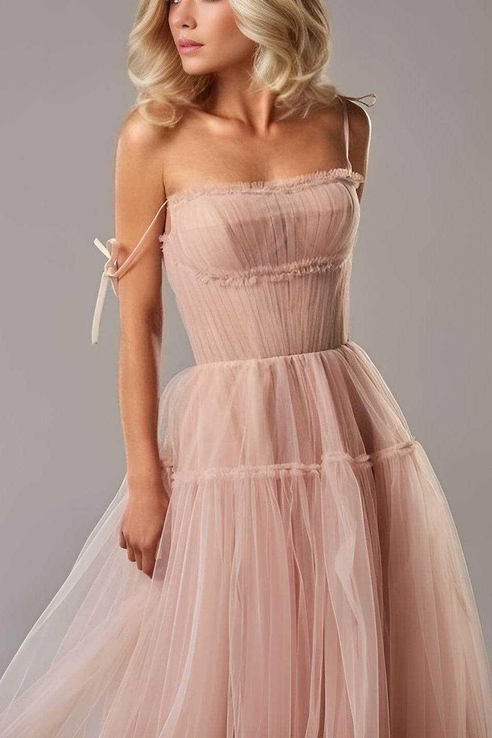 Close-up of pink pleated bodice with bow tie detail on the SARKA evening gown.
