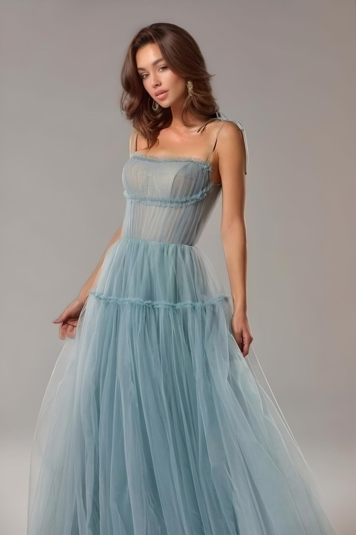 Close-up of pleated bodice and spaghetti straps with bow tie detail on the SARKA evening gown.