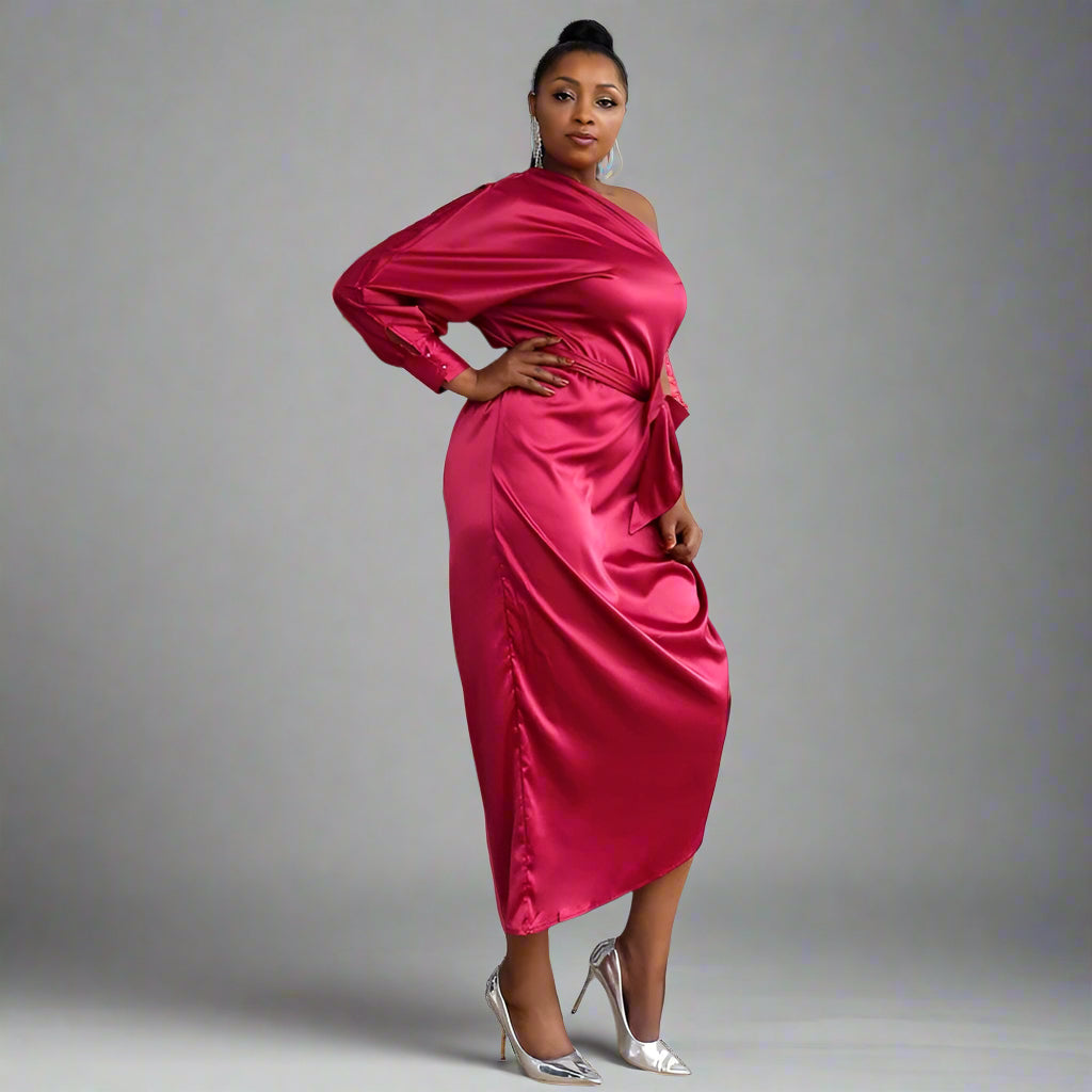 Side view of the SASKIA gown highlighting the one-shoulder design and asymmetrical silhouette.