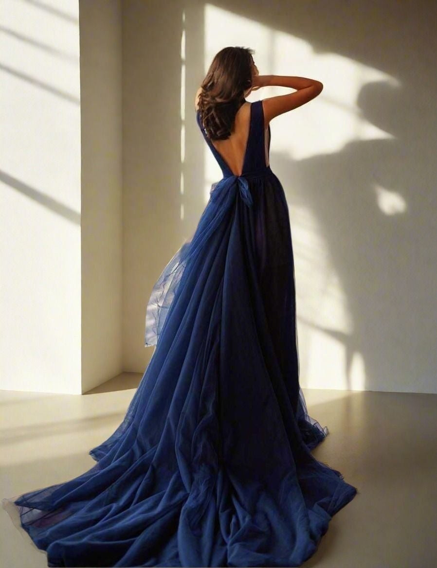 Back view of navy blue SHILOH gown, highlighting its open-back design and bow.