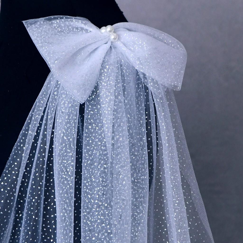 **Detail of the luxurious bows on the Glitter Sparkling Bridal Wings Veil.- White