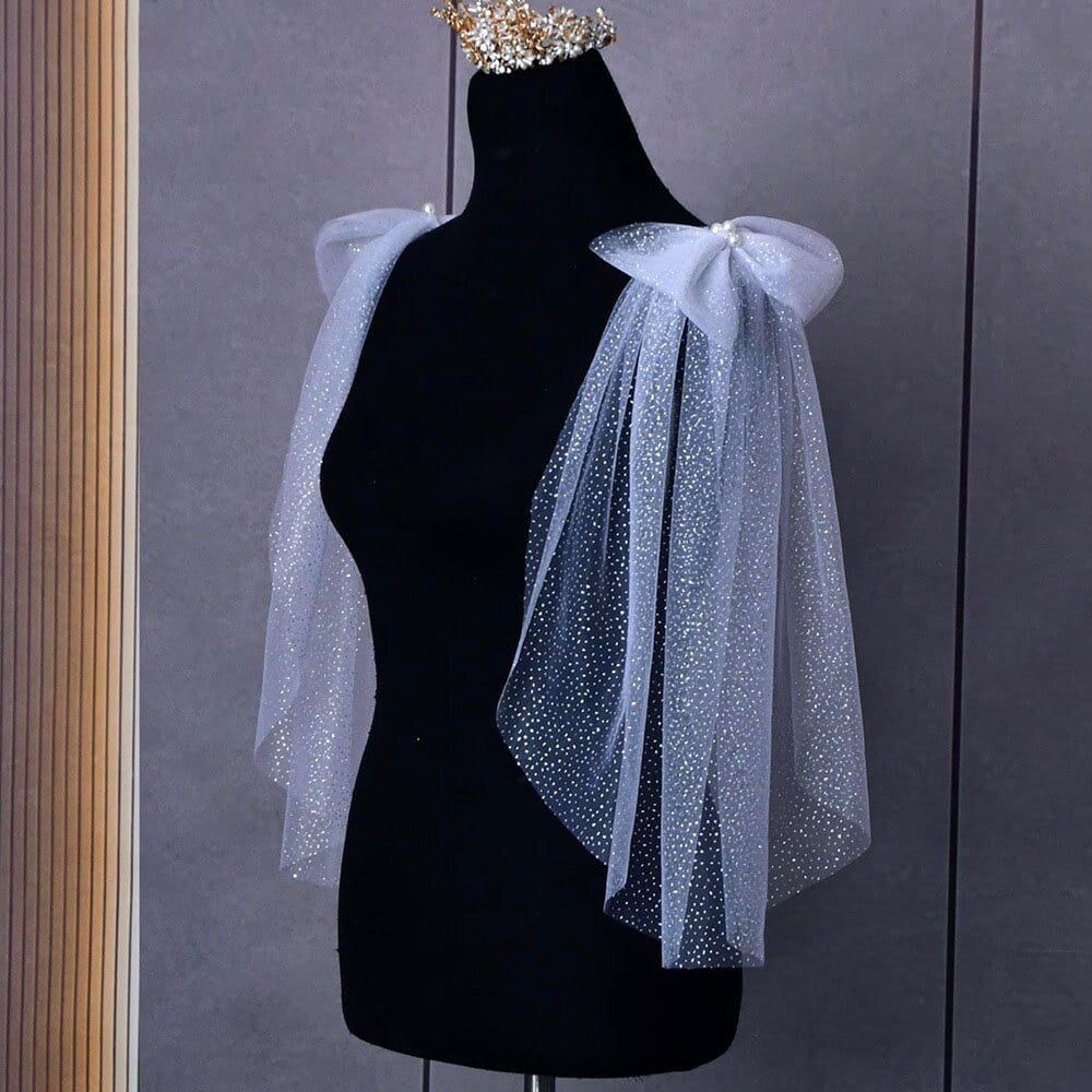 Shimmering effect of the Glitter Sparkling Bridal Wings Veil on figurine.