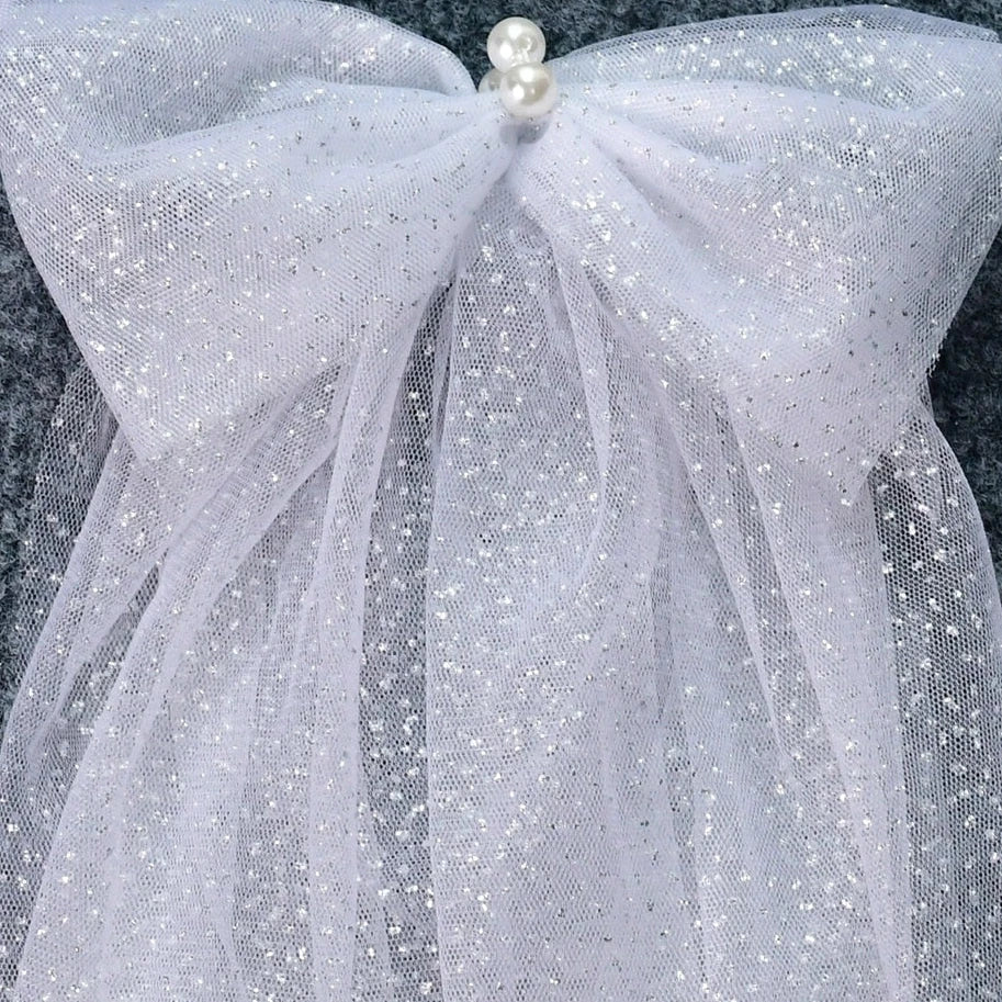 Flat lay of the Glitter Sparkling Bridal Wings Veil with pearls and luxurious bows.