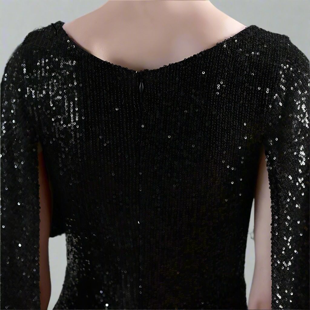 Black sequin dress details against a neutral background