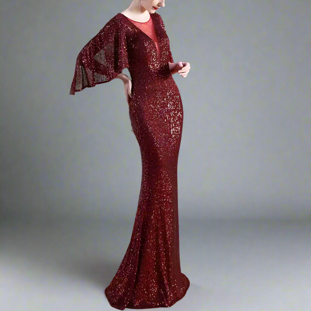 Woman wearing a burgundy sequin dress with a matching jacket indoors.