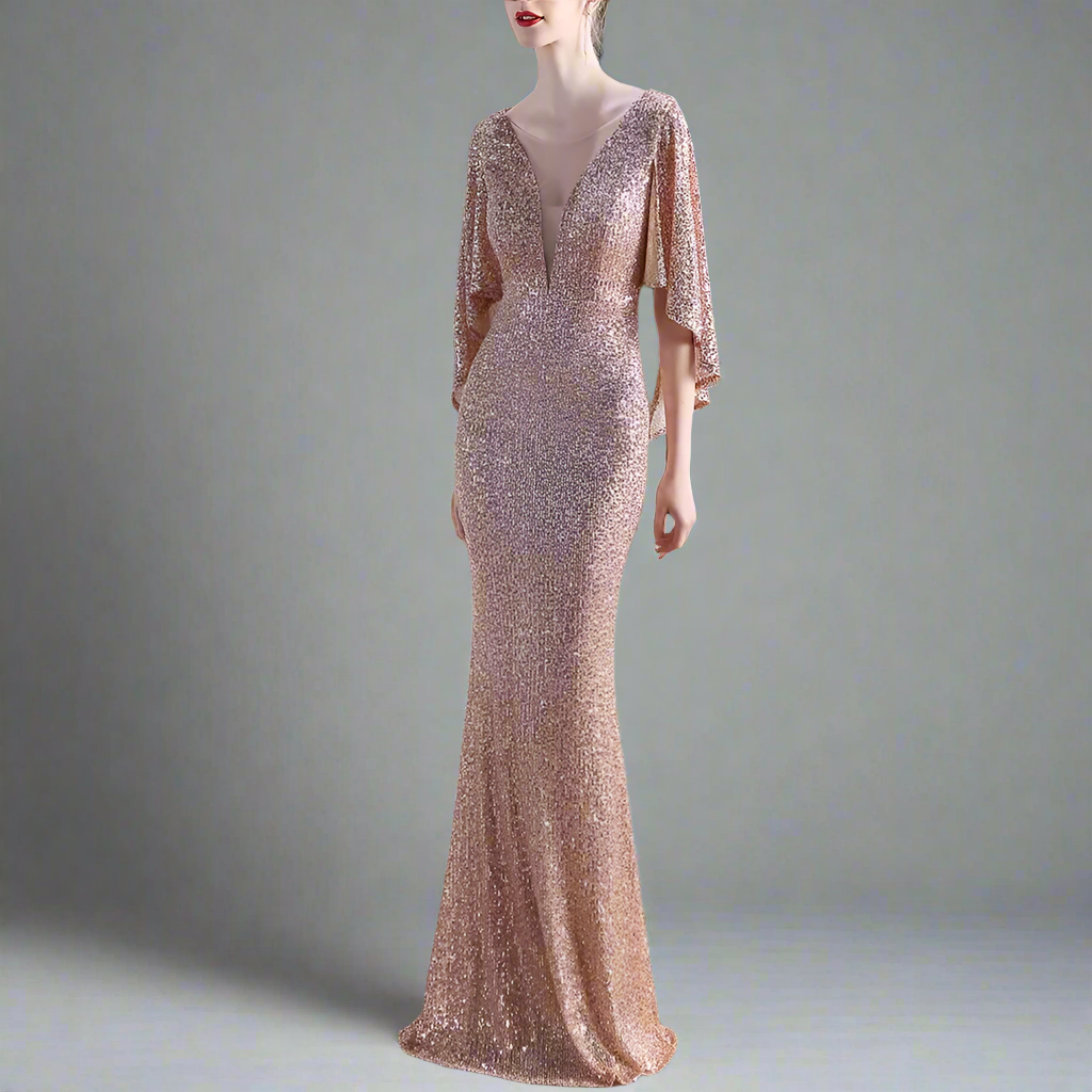 Woman wearing a rose gold evening gown with a blurred indoor background