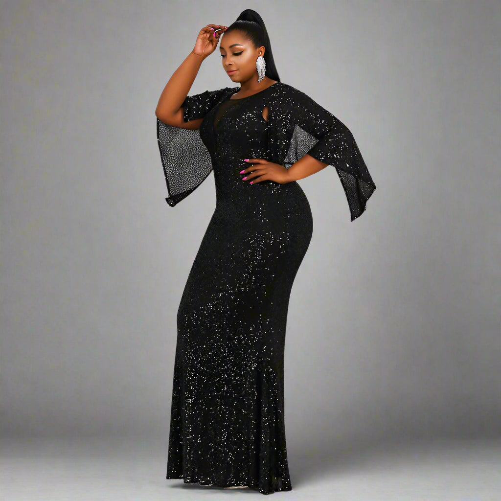 Glamorous shot of woman wearing the Stacey Formal Gown under studio lighting, showcasing its sparkle.