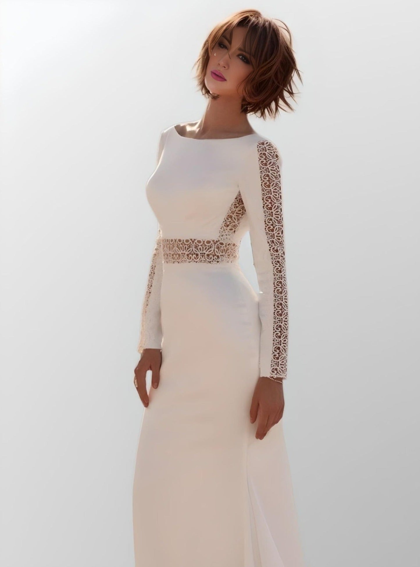 Bride in elegant full-coverage LYDIA Gown with intricate lace accents and long sleeves