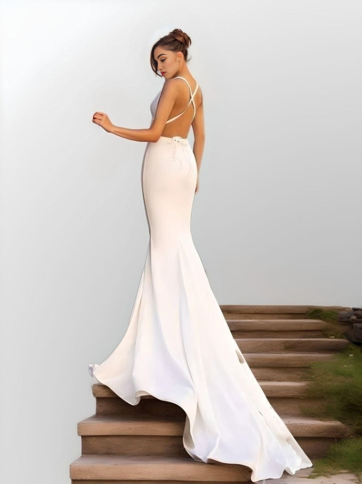 Backless design of LYNETTE Wedding Gown with sweep brush train.