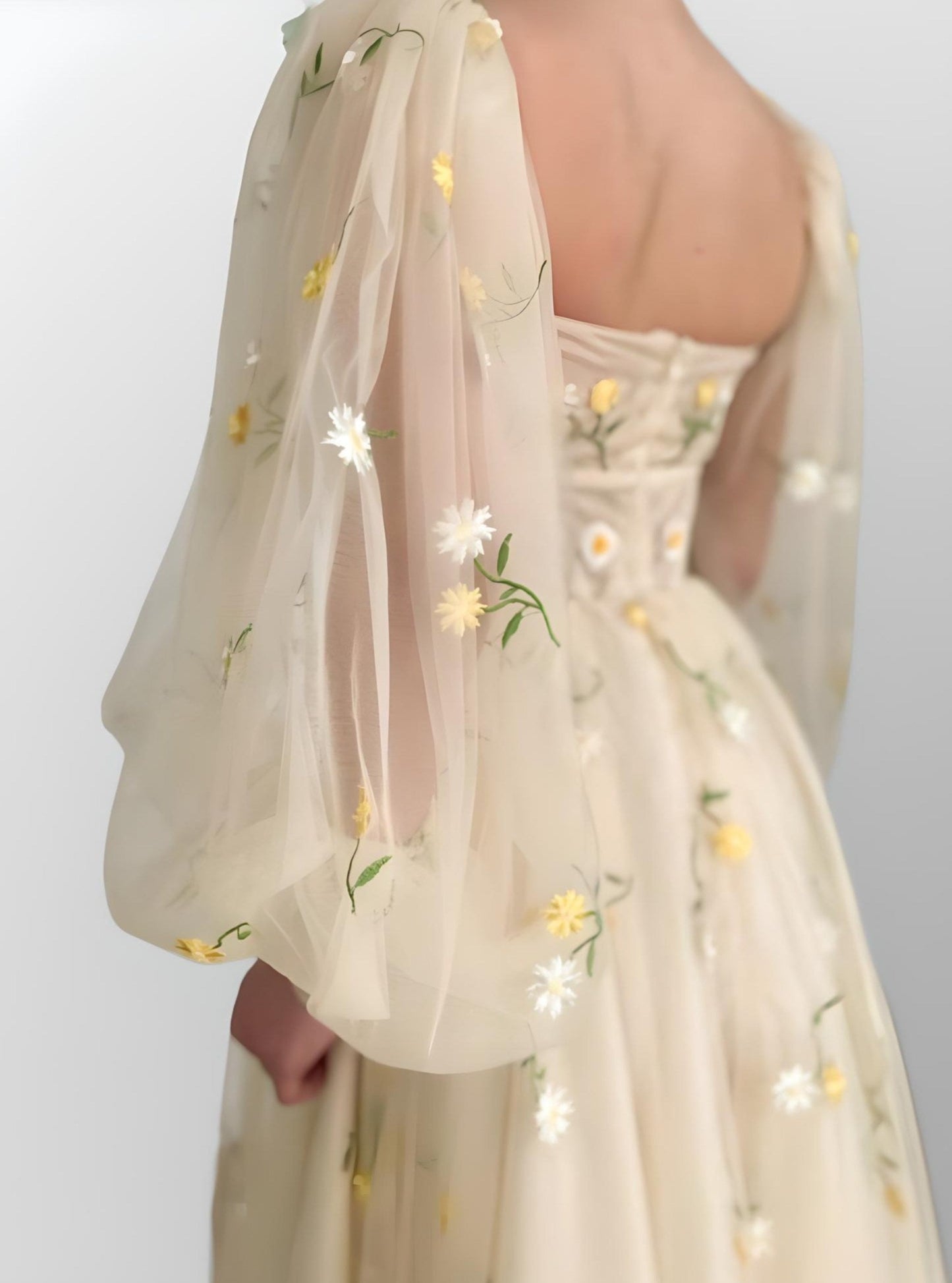 Detail of puffy tulle sleeve with floral embroidery on Madison formal dress.