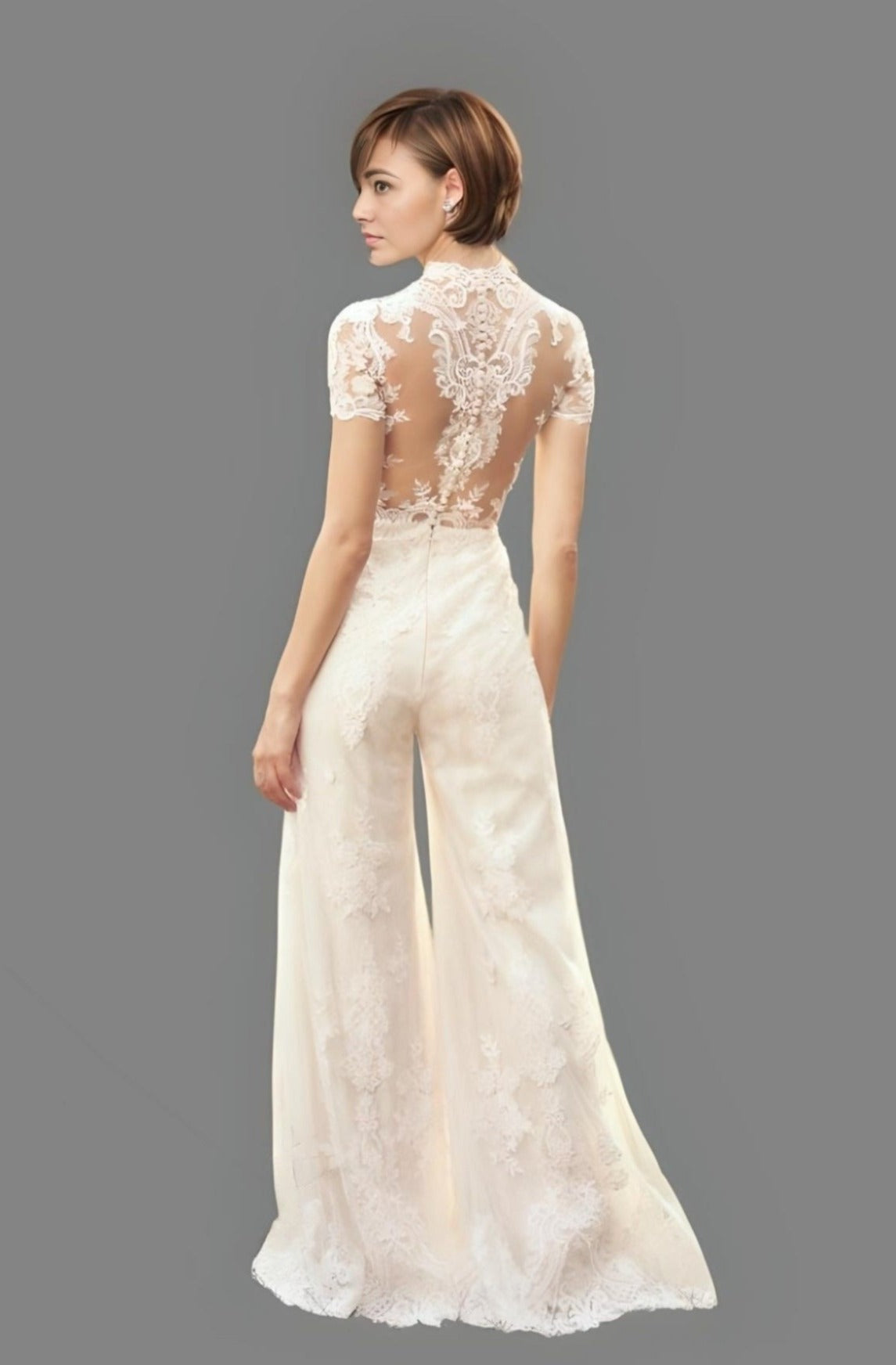 Bride showing MAGDALENA bridal pantsuit with lace appliques and button back
