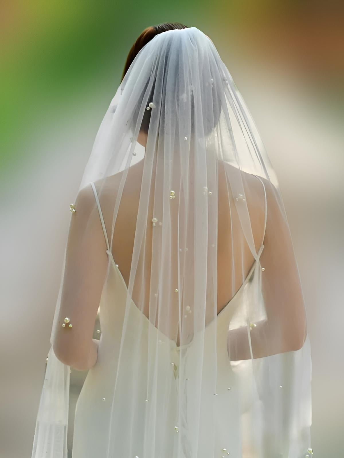 Back view of bride showcasing soft tulle and pearl accents