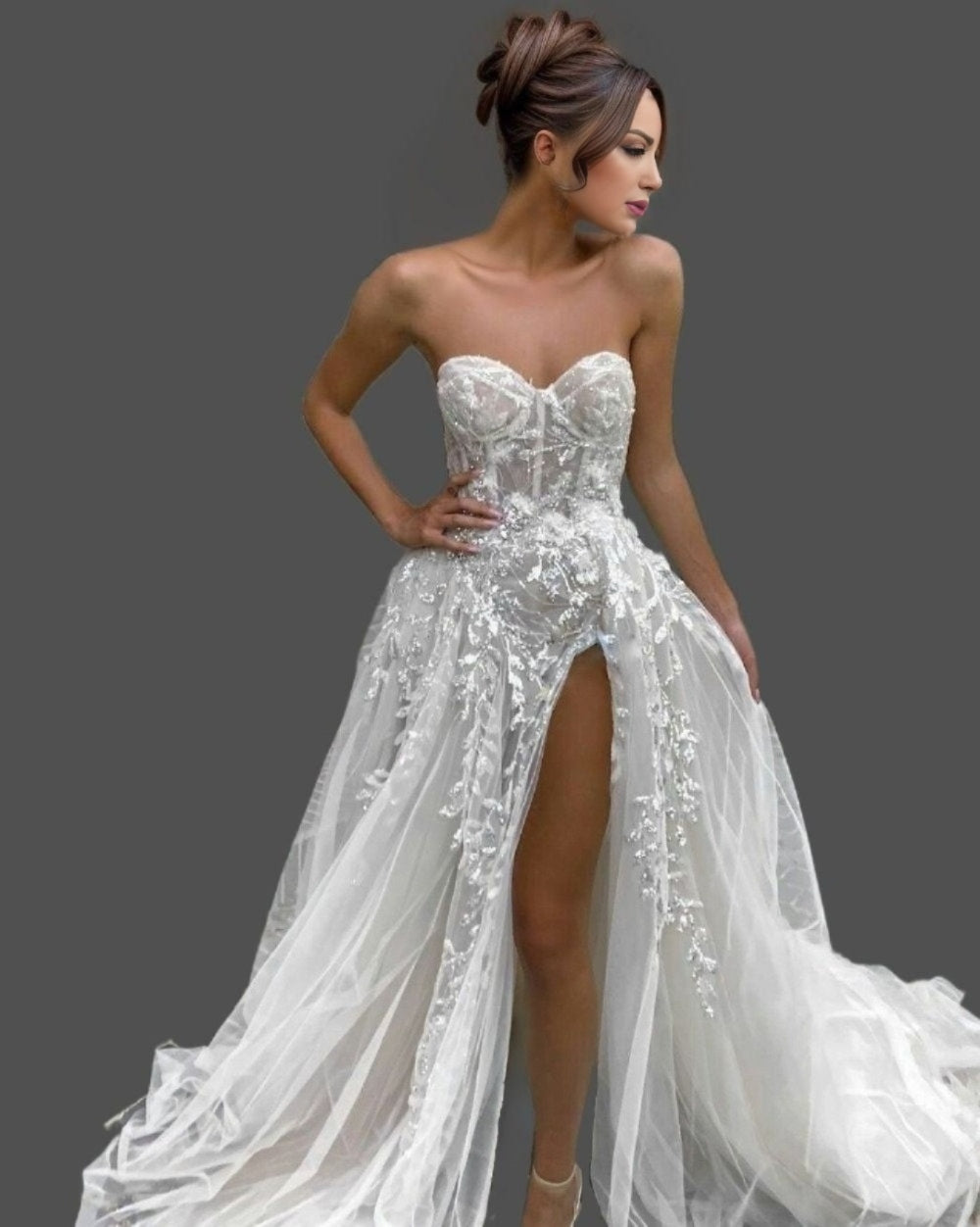 Close up view of MINA Bridal Gown showcasing delicate lace and beading with high sexy slit
