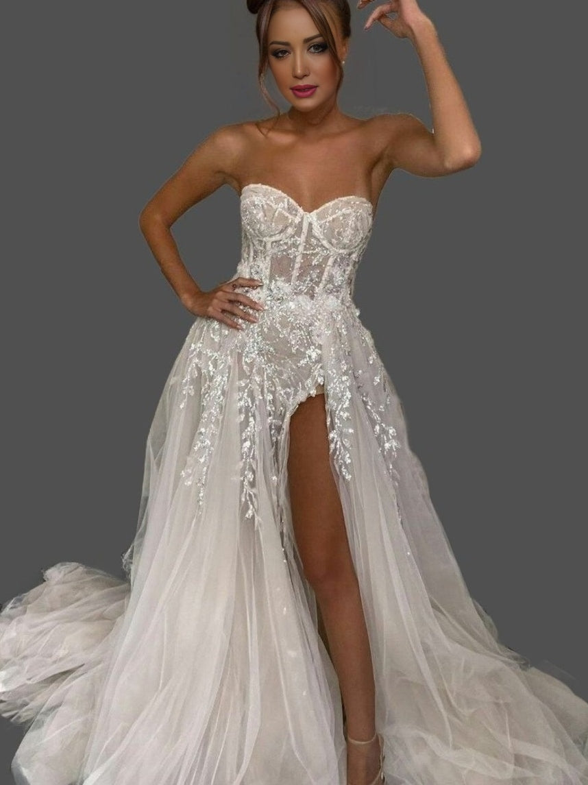 Bride posing in MINA Wedding Dress, highlighting side slit and flowing fabric