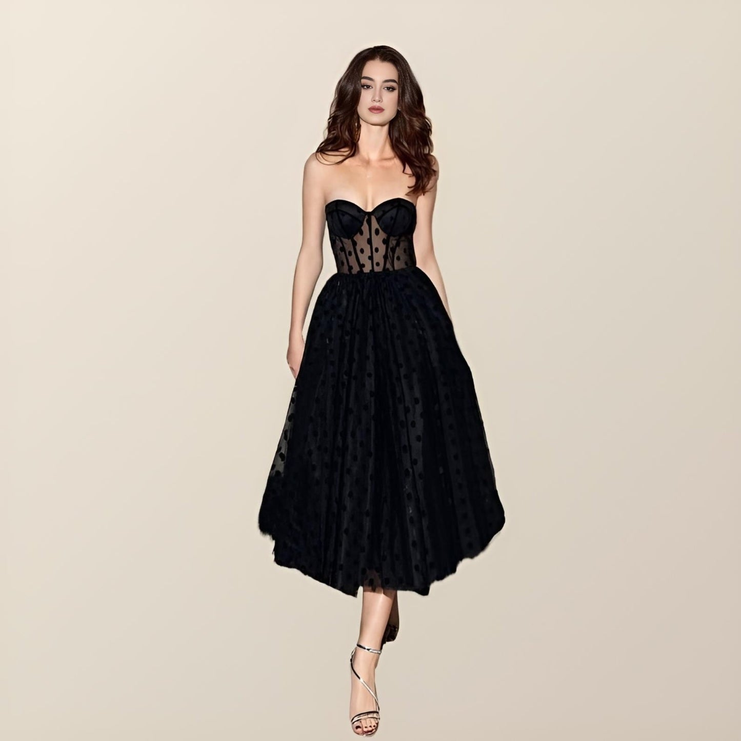 Woman wearing polka dot tulle Miranda Formal Dress with sweetheart neckline and tea-length skirt