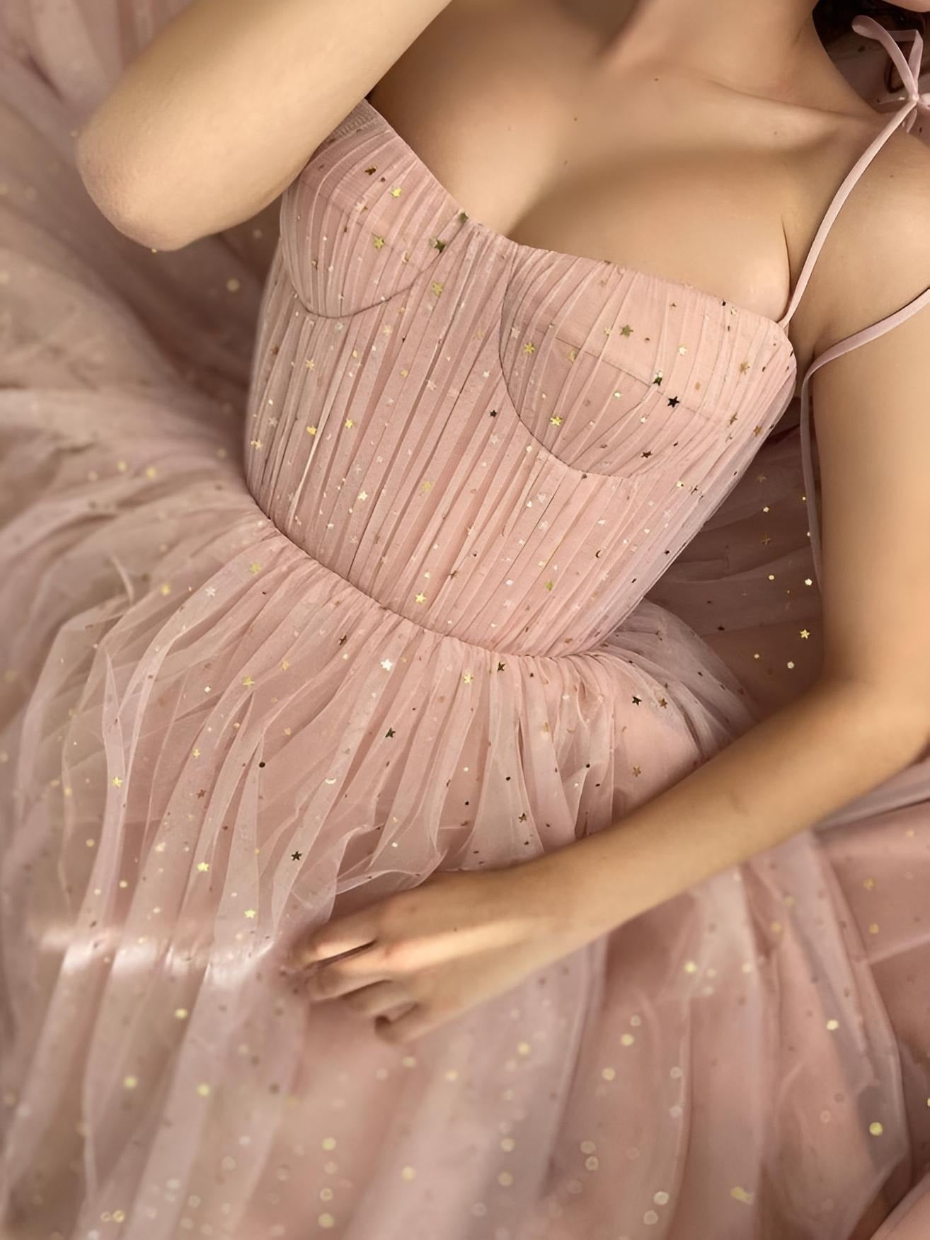 Close-up of pink tulle fabric with gold stars and pleated bodice on MYLEE gown