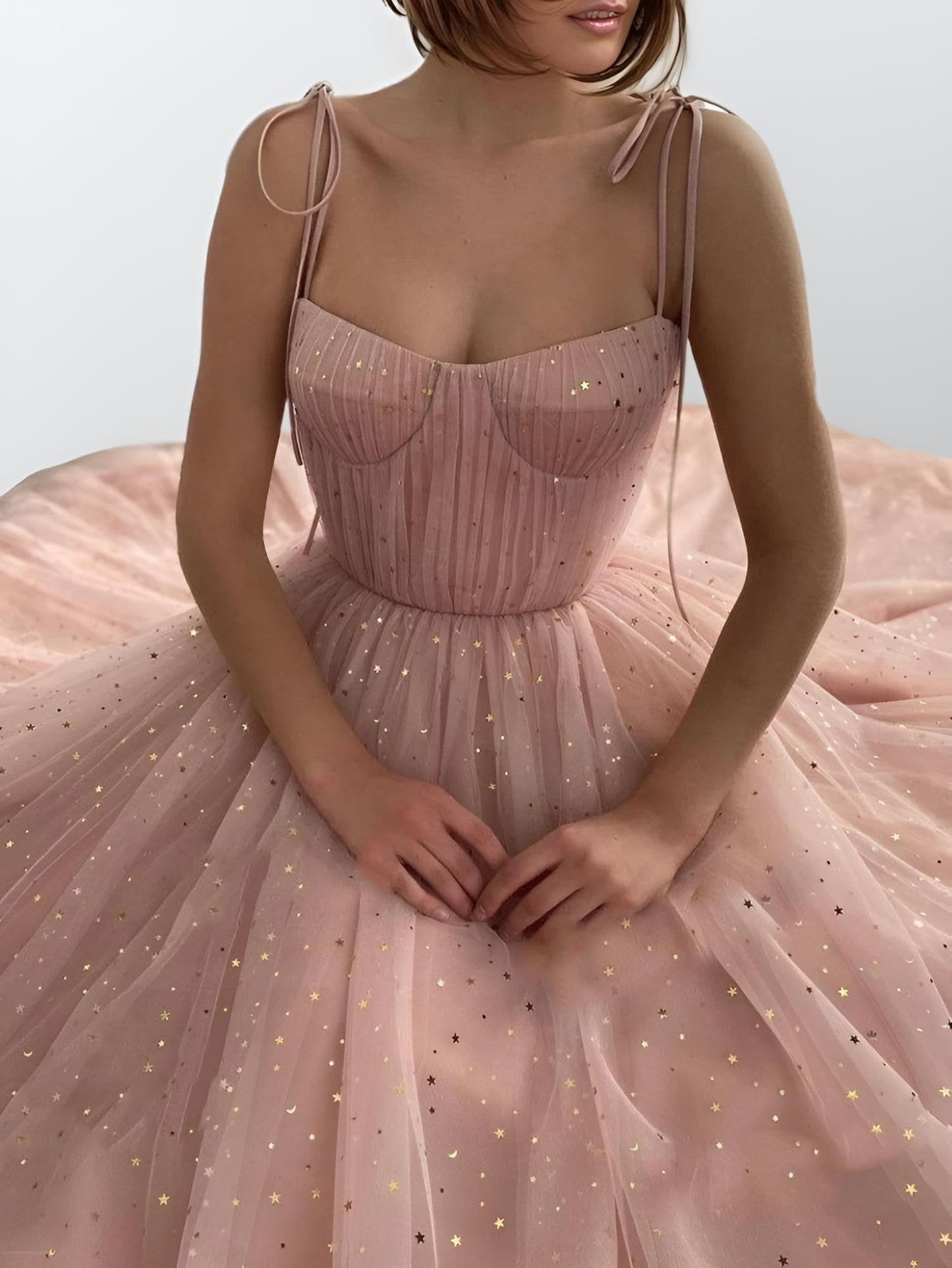 Close-up of starry tulle fabric and pleated bodice on MYLEE gown