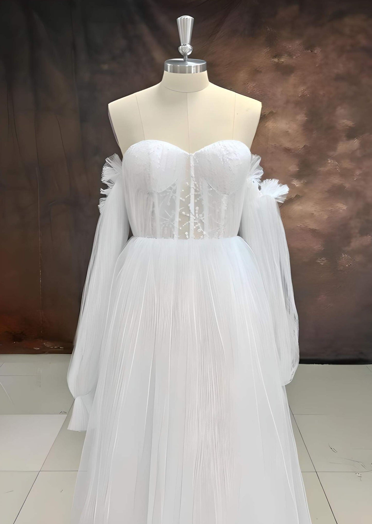 OLIVIA dress in white displayed on mannequin, showcasing dress design and puff sleeves