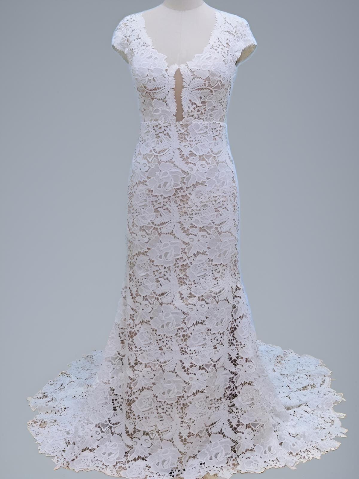 Full-length shot of lace PARIS wedding dress with short cap sleeves and sweep train on a figurine