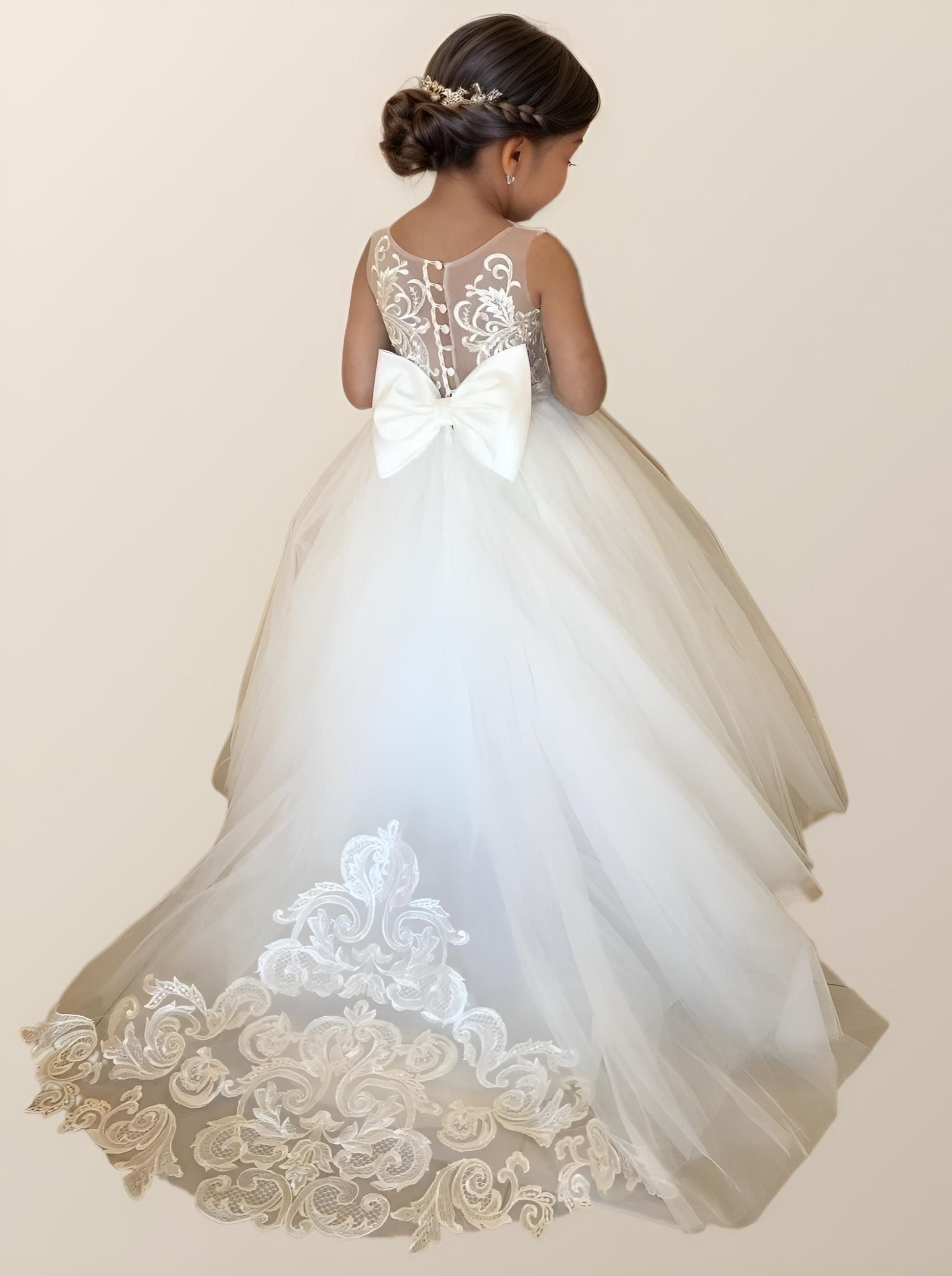 Flower girl wearing PATRICIA Girl Dress with floral appliques and bow