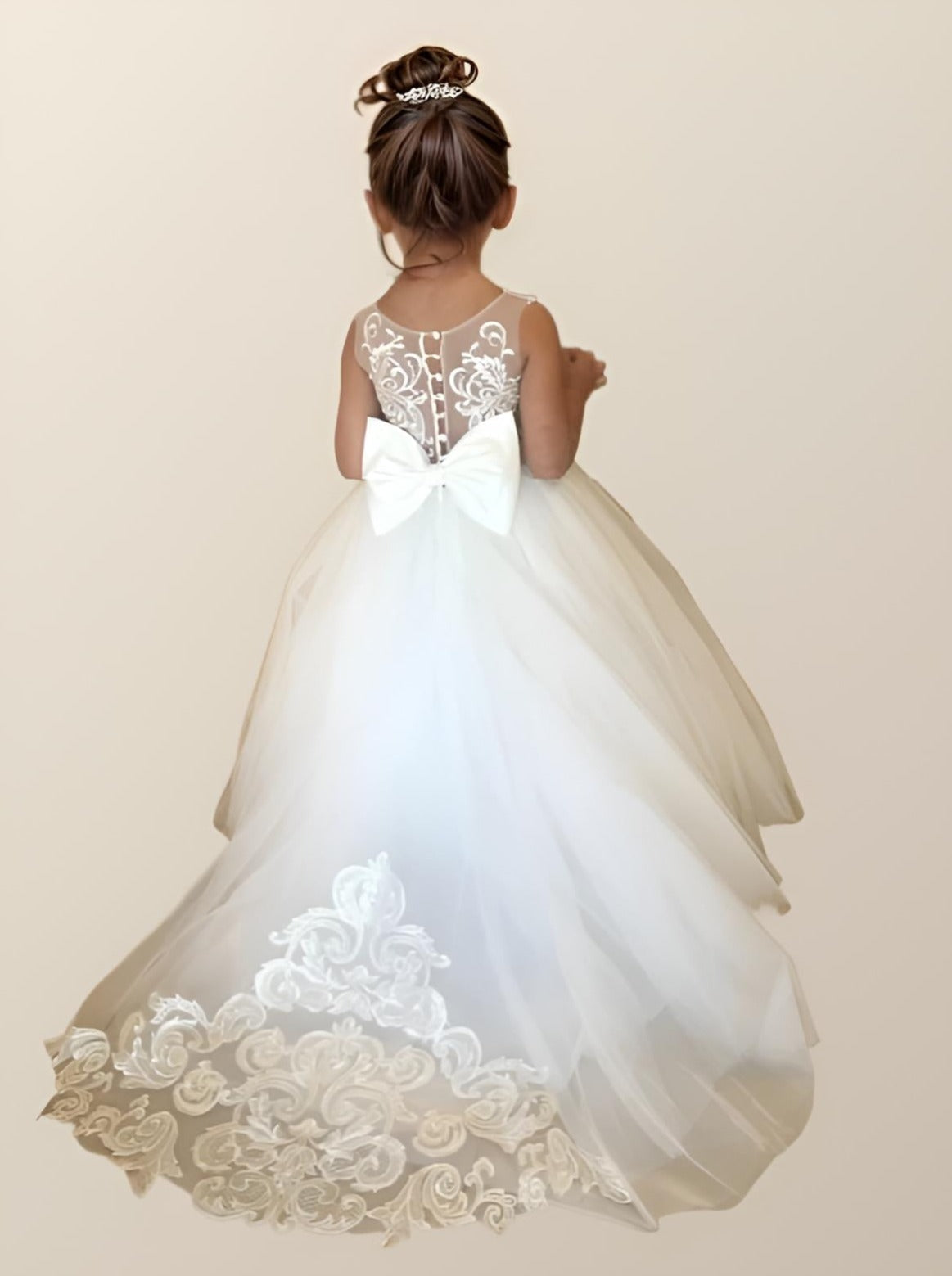 PATRICIA Girl Dress worn by a child, showing floral and lace details with back bow