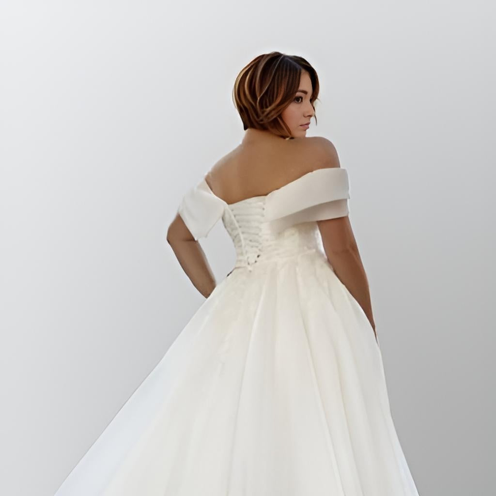 Close-up of PEARL Wedding Dress showing the intricate lace appliques anc lace-up closureon the bodice