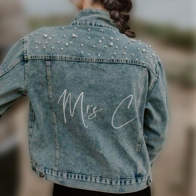 Full back view of denim jacket showcasing elegant wedding day outerwear