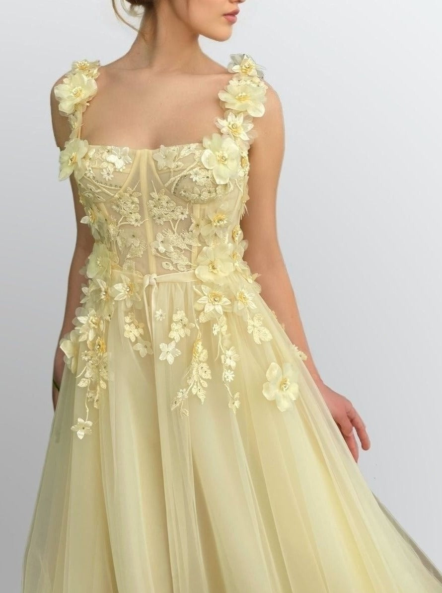 Close-up of floral bodice appliques on RAYA light yellow tulle formal gown.