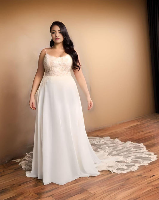 Plus-size bride wearing a boho chiffon wedding dress with spaghetti straps.