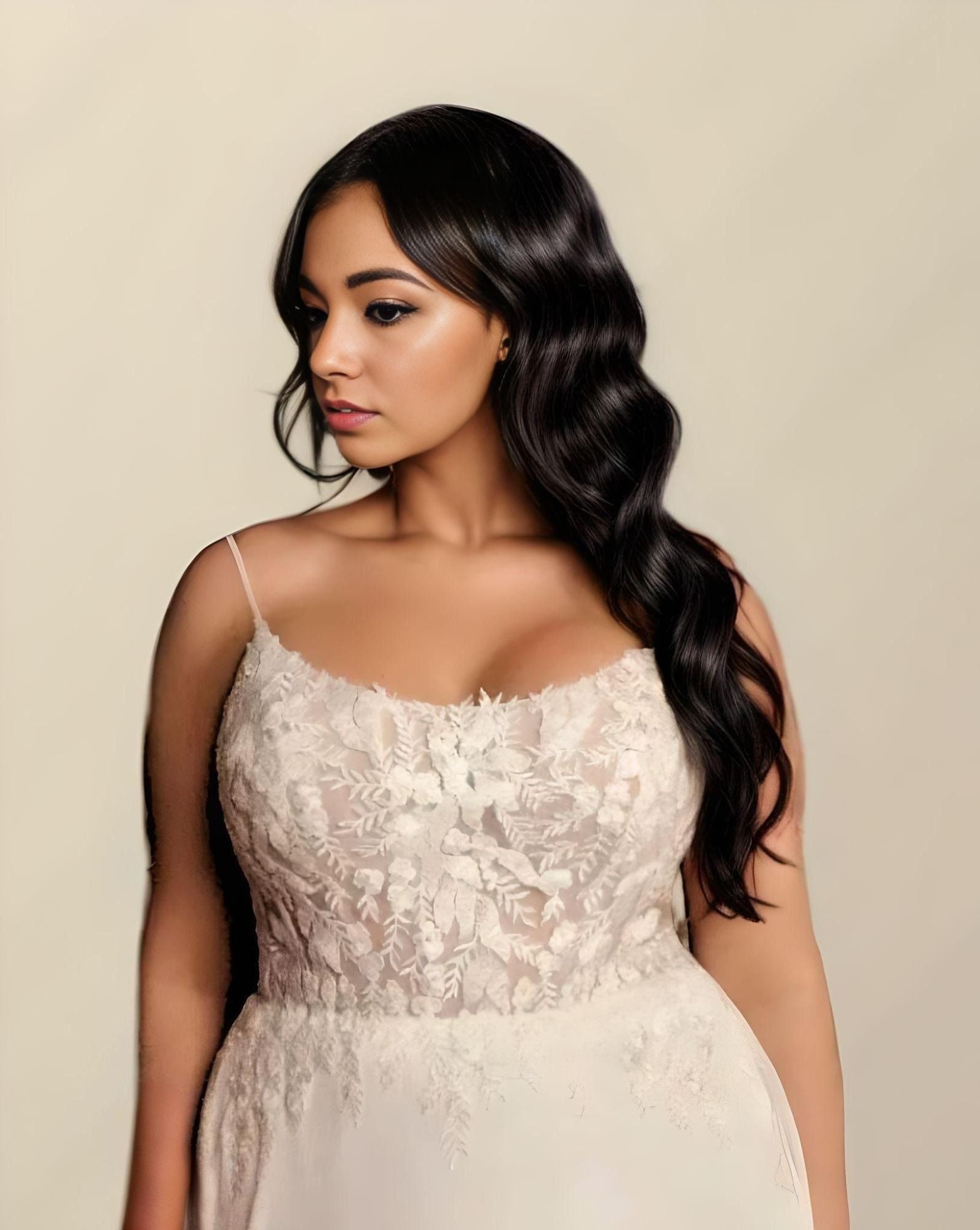 Soft, romantic lace detailing on the bodice of a plus-size wedding dress