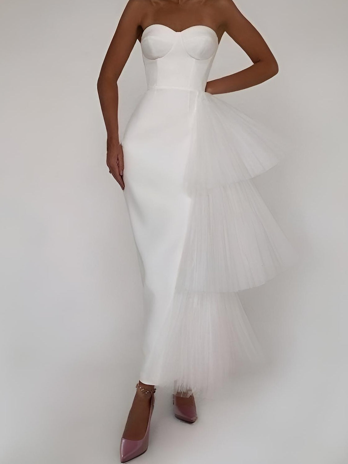 Woman posing in a white tiered tulle black prom dress