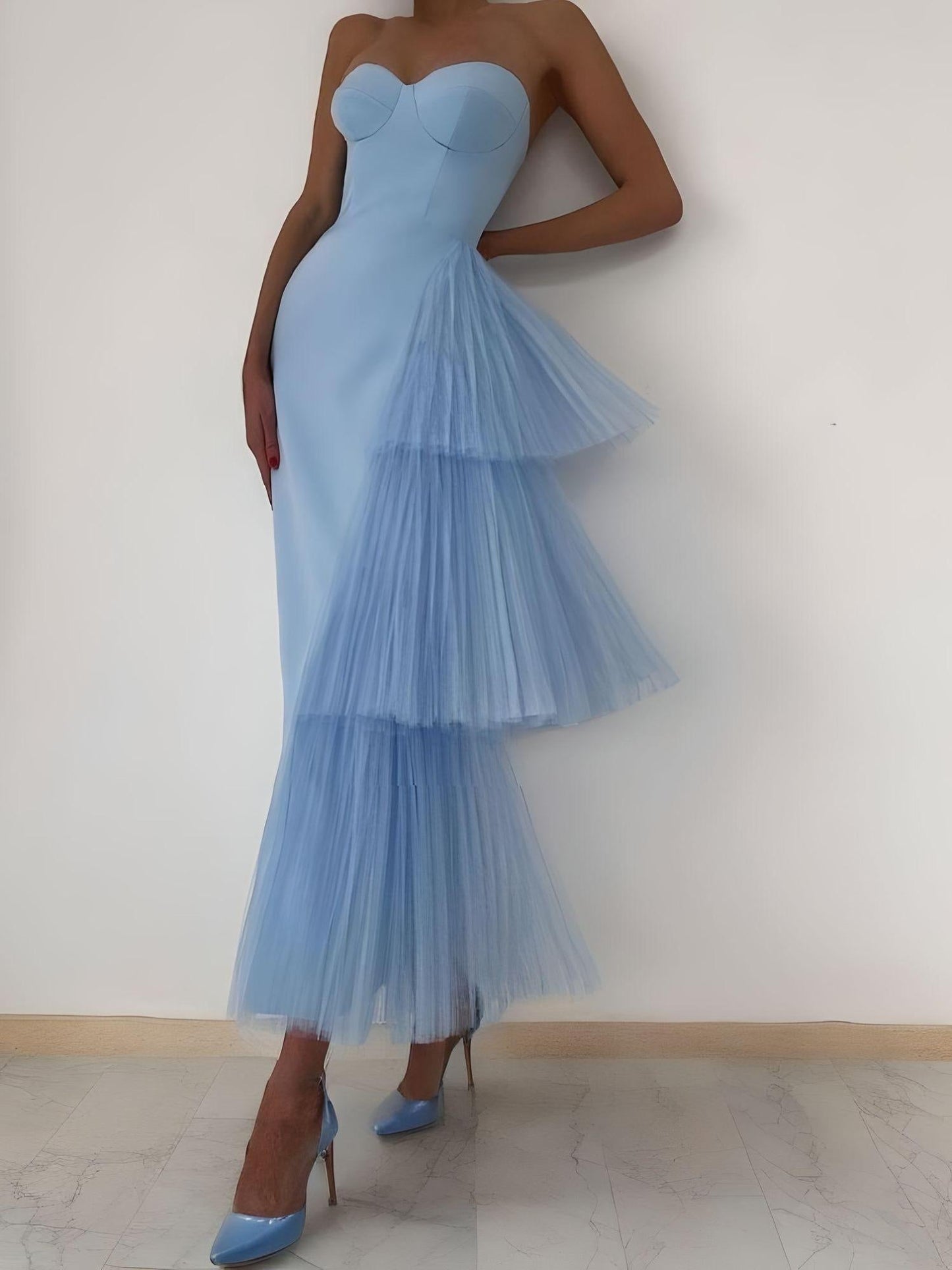 Woman wearing a light blue sweetheart neckline prom dress
