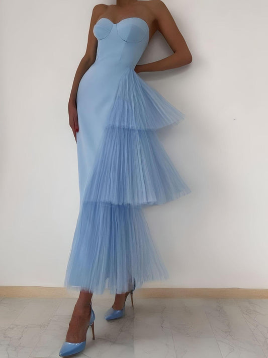 Woman wearing a light blue sweetheart neckline prom dress