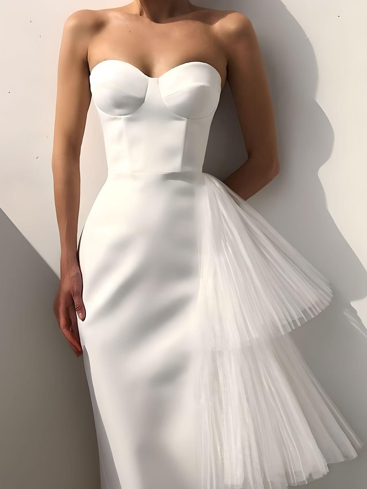 Woman wearing white sweetheart neckline prom dress